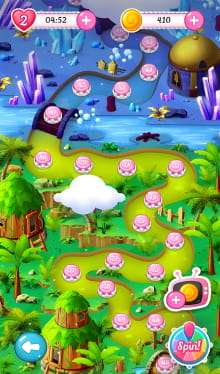 Candy Planet game map screen showing a colorful path with levels marked by pink circles. The top part of the map is icy with crystals and a building, while the bottom part is lush and green with trees and huts. Hearts, timer, and coin indicators are at the top, and navigation buttons are at the bottom.